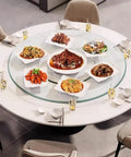 Big Boy Sized Round Lazy Susan With Dead Silent Glide 360 Degree Rotation Serving Tray featuring various dishes on a round glass table.