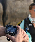 Person wearing Quad Ci Wrist Dive Computer With Customizable ZH-L16C Algorithm For Your Personal Dives, outdoors.