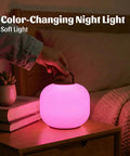 Pink cordless RGBW LED table lamp with remote on bedside, portable outdoor lantern, IP44 waterproof dimmable battery mood light