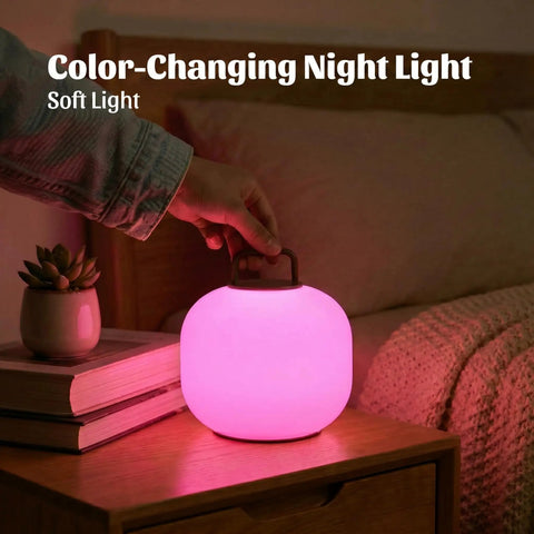 Pink cordless RGBW LED table lamp with remote on bedside, portable outdoor lantern, IP44 waterproof dimmable battery mood light