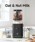 Top Rated 3-In-1 Cold Press Juicer For Juice, Nut Milk And Sorbet with oats and nuts in the hopper, pouring nut milk.