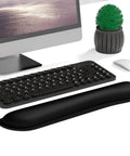 Cozy Memory Foam Keyboard Wrist Rest With Non Slip Base For Comfort And Pain Relief Ergonomic Mouse Pad Rest For Gaming Laptop And Computer Desk Use Cute Black placed in front of a desktop keyboard.
