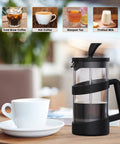 Compact 12 Oz Mini French Press Coffee Maker For Camping And Travel with black finish on table beside a white cup