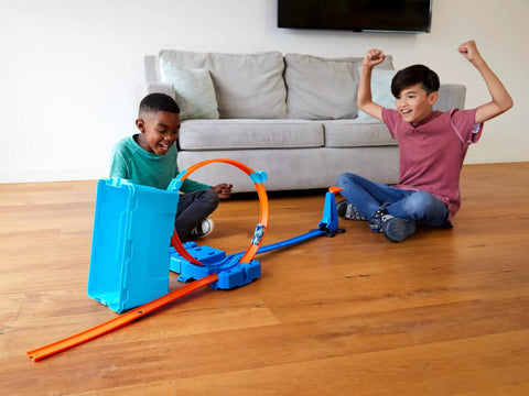 Kids playing with Track Builder Multi Loop Toy Car Track Set With 10 Feet Of Track In Storage Box Portable Kid Friendly Stunts Playset.