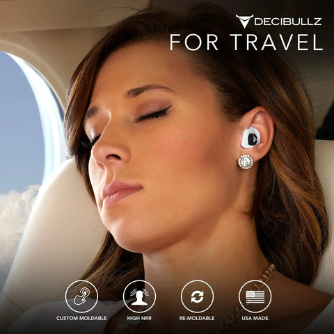 Woman wearing 25 Decibel Noise Reduction Earplugs Custom Molded Reusable Hearing Protection For Noise Sensitivity And Flights.