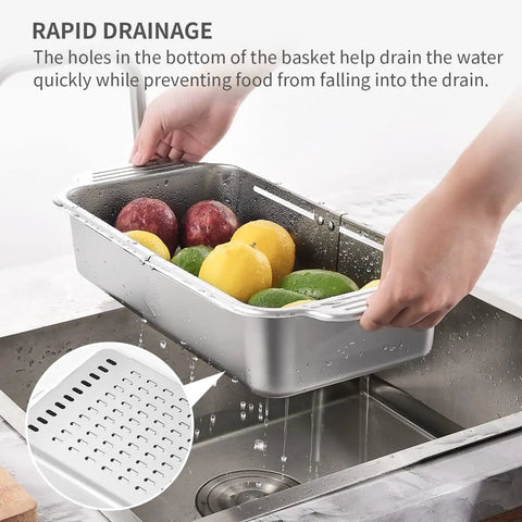 Extendable Over Sink Colander In Stainless Steel being used to wash fruits, showing drainage holes and adjustable fit over sink.