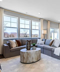 Living room with one and one eighth inch curtain rods telescoping from 144 to 240 inches over large windows, warm gold finish
