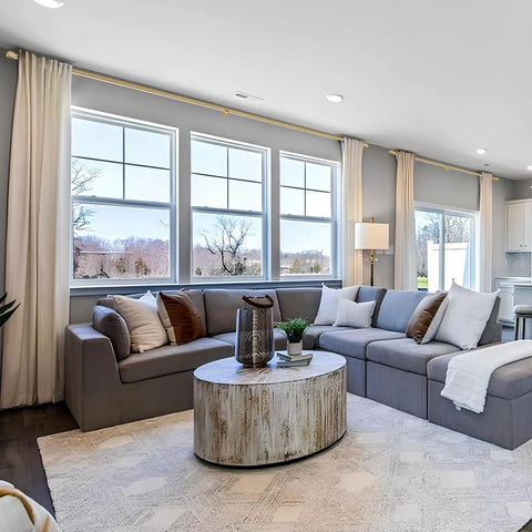 Living room with one and one eighth inch curtain rods telescoping from 144 to 240 inches over large windows, warm gold finish