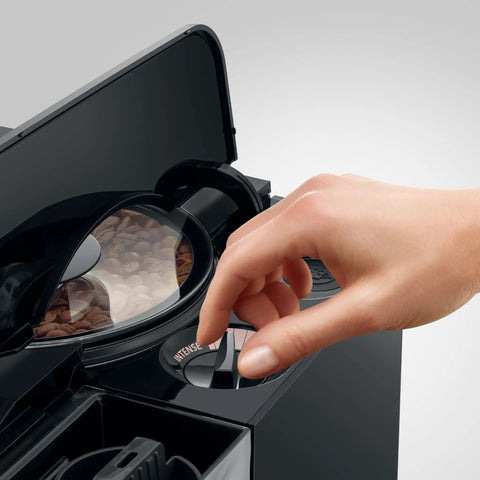 Hand adjusting the settings on the Top Tier Automatic Coffee Maker In Sleek Piano Black With One Touch Brewing.