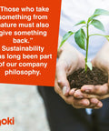 Person holding a small plant with soil, accompanied by a quote about sustainability and company philosophy.