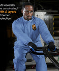 Man wearing Breathable Particle Protection Coveralls With Zipper Front, Elastic Back, Wrists And Ankles, Blue Reflex Design, XL Disposable Workwear, Five Layer SMS Material For Dust And Dirt, Case Of 24, operating machinery.