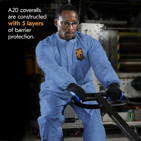 Man wearing Breathable Particle Protection Coveralls With Zipper Front, Elastic Back, Wrists And Ankles, Blue Reflex Design, XL Disposable Workwear, Five Layer SMS Material For Dust And Dirt, Case Of 24, operating machinery.