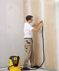 Person using vacuum hose for hand sanding blocks 13 ft lightweight flexible hose connected to industrial vacuum on wall