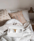 Premium Collapsible Oxford Cloth Drawer Organizer With Lid For Underwear Bras And Bathing Suits shown on a bed with decorative pillows.