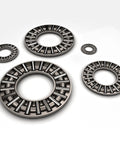 Thrust needle roller bearings with washers; set of five metal-gray bearings in varying sizes