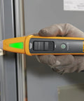Person using 4 In 1 Breaker Finder, NCV Detector, Socket Tester And LED Flashlight on a circuit breaker panel