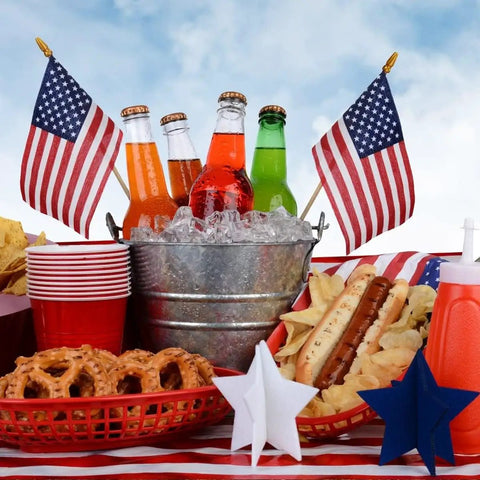 12 Pack Small American Flags On Sticks 4x6 Inch Mini US Flags For Outdoor Use with picnic items on table for 4th of July celebration