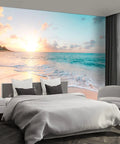 Bedroom with self adhesive canvas wall mural depicting a serene ocean sunrise scene with a sandy beach and calm waves.
