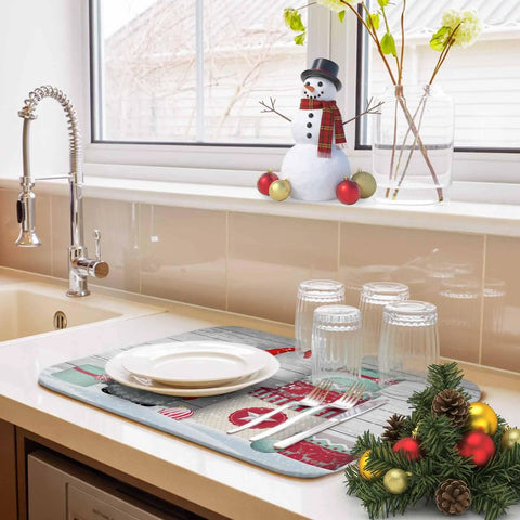 Cozy Holiday Dish Drying Mat With Gnome Design 18 By 24 Inches in use with glassware, on kitchen counter by a window.