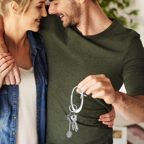 Couple holding an Extra Large Chrome Carabiner Keychain For Keys, Purses, Backpacks And Bags, silver alloy metal ring with keys attached.