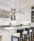 4 Light Linear Kitchen Island Pendant Light With Clear Glass Shades, Brushed Nickel Chandelier over modern farmhouse kitchen island.