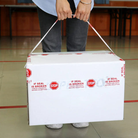 Person carrying box sealed with Security Packing Tape With Pre Printed If Seal Is Broken Check Contents Before Accepting Seal Integrity.