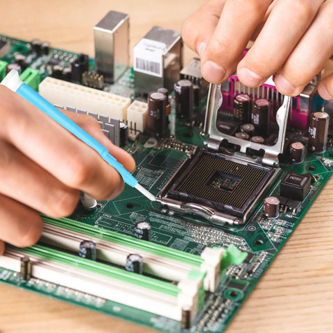Person using Five Piece Ceramic Insulated Screwdriver Set For Precision Electronics Repair And Watchmaking on a circuit board.
