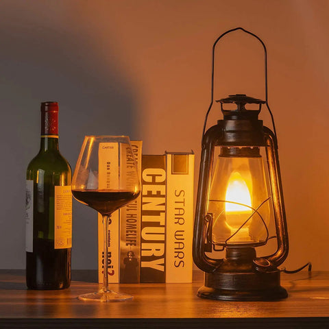 Pack Of 2 Vintage Rustic Lantern Lamps With Edison LED Bulbs, Bronze Rust Finish on a desk near wine and books