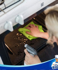 MR.SIGA microfiber cleaning cloth, lime green, used to wipe oven interior; in-use side view