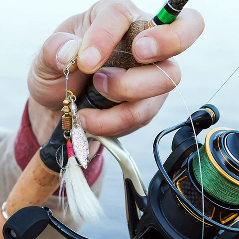 Spinner Blades With Ball Bearing And Spring Pins For Lure Making, Willow Tail Spinner Blades With Swivels, 30 Pcs Set, Durable Iron Construction, Pro Grade Build, Corrosion Resistant, Perfect Fish Attractor For Lure Building. hand holding silver willow spinner blade on fishing rod