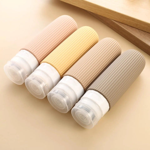 TSA Approved Travel Bottles Set Three Ounce Silicone Squeeze Containers Leak Proof BPA Free For Grab And Go Toiletries Reusable Travel Size Bottles In Clear Bag 4 Pack showing four ribbed bottles in soft colors.