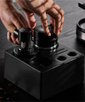 Straight Fire Dual Bearing Espresso Distributor And Tamper Combo Fits 51 54 58mm Filter Baskets, black handheld coffee tool in use.