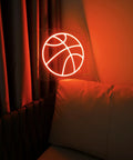 Basketball Neon Sign LED Light 11.8 Inch for Bedroom Decor and Game Room Aesthetic, glowing on a wall in a dimly lit room.