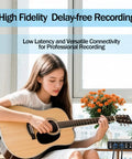Woman playing acoustic guitar with 2x2 USB Audio Interface With Phantom Power, 24-Bit/192kHz Recording Card on table