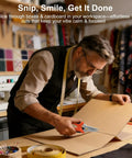 Person using 7 Inch Heavy Duty Gravity Shears With Micro Serrated Japanese SUS420J2 Blades to cut cardboard in a studio.