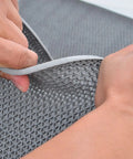 Close-up of a Heavy Duty Drainage Mat 3x16 ft PVC Grippy Non Slip Floor Mat With Holes, shown in grey material with drainage perforations.