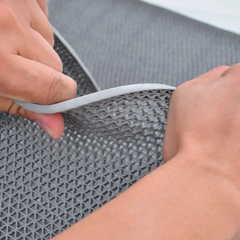 Close-up of a Heavy Duty Drainage Mat 3x16 ft PVC Grippy Non Slip Floor Mat With Holes, shown in grey material with drainage perforations.
