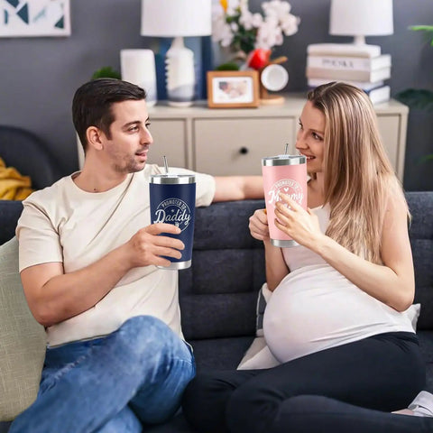 Celebrate The Freshly Minted Arrival Of New Mama And Papa With This Awesome Gift Set For Couples Featuring Matching Tumblers Paired With A Warm Cozy Candle Perfect For Baby Showers First Fathers Day And Parenting Squad Celebrations. A couple enjoys matching insulated tumblers at home.