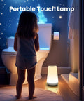Child looking at Dimmable Touch Night Light With 360 Degree Control, Portable Bedside Lamp, 5 Brightness Levels And 13 RGB Colors in bathroom