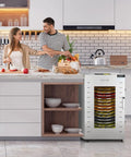 Heavy Duty 16 Trays Commercial Food Dehydrator For Making Sweet Beef Jerky And Dried Fruit All Week Long Without Breaking A Sweat Featuring Stainless Steel Racks And A Reliable 1500 Watt Motor in a modern kitchen with fresh produce.