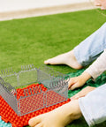 Child assembling Slick Light Gray Plastic Miniature Fence Kit With Dead Simple Snap Together Design For Farm Diorama And Prison Model Builds.