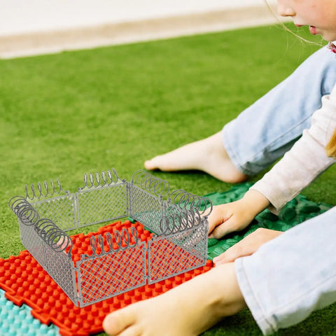 Child assembling Slick Light Gray Plastic Miniature Fence Kit With Dead Simple Snap Together Design For Farm Diorama And Prison Model Builds.