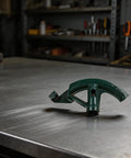Heavy Duty Hand Bender For Copper Pipe And Conduit Tube on metal surface, showcasing ergonomic grip and durable steel construction.
