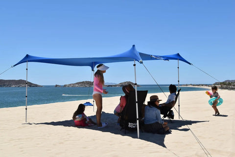 Easy Setup Beach Canopy Tent 8.5x9 Ft UPF50 Plus Sun Shade Portable Four Post Shelter for beach use, showing blue canopy in sand.