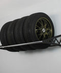 Rock Solid Heavy Duty Steel Wall Mount Tire Rack holding four tires securely, adjustable black garage storage shelf supports 400 pounds.