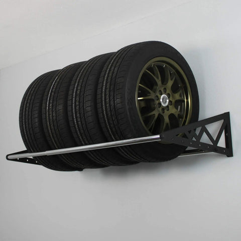 Rock Solid Heavy Duty Steel Wall Mount Tire Rack holding four tires securely, adjustable black garage storage shelf supports 400 pounds.