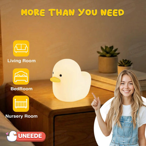 Cute Duck Night Light For Nursery And Bedroom on a bedside table, woman pointing to soft illuminated silicone duck lamp.