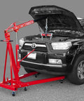 Top Shelf 2 Ton Steel Garage Engine Hoist With Folding Frame And Hydraulic Long Ram Jack positioned over a black vehicle's engine.