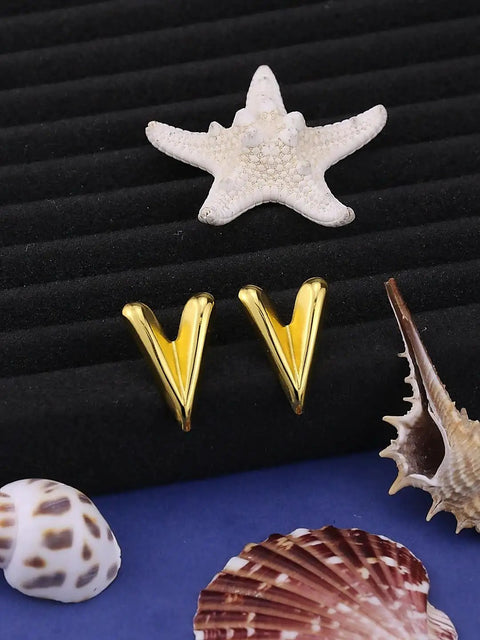 Chunky Gold Plated Earrings for Women, 18K Gold Plated Stainless Steel V Shape Heart Shell Studs displayed with seashells