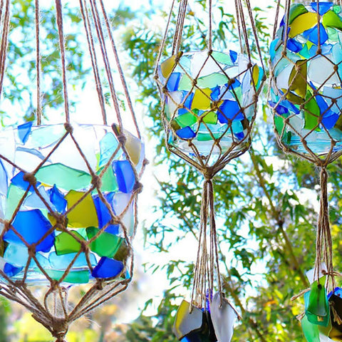 Colorful glass mosaics hanging from strings showcasing Clear Multipurpose Adhesive For DIY Projects With Low Odor Self Leveling And Flexible Bond UV Resistant Paintable Washer Dryer Safe Acid Free Formula For Crafts Jewelry Making Home Repairs And Hobby Projects.